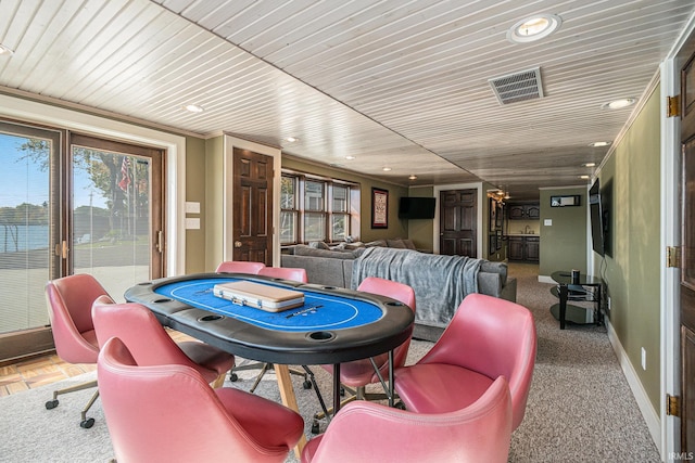 recreation room featuring ornamental molding and carpet flooring