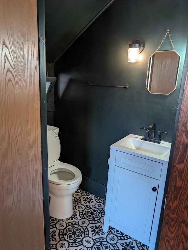 bathroom with vanity, toilet, and tile patterned floors