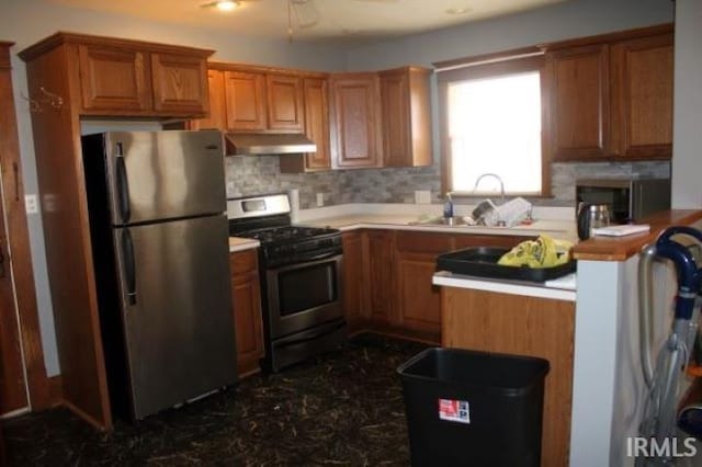 kitchen with sink, stainless steel appliances, and tasteful backsplash