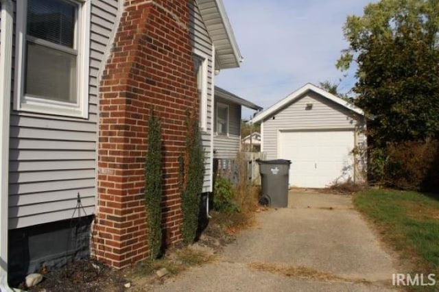 view of property exterior with an outdoor structure and a garage