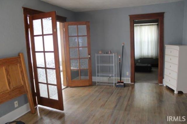 doorway with french doors and hardwood / wood-style flooring