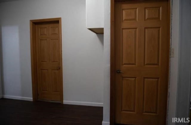 corridor with dark wood-type flooring