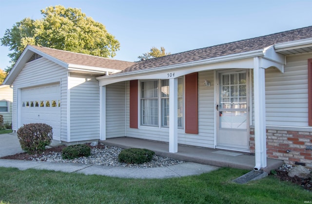 property entrance featuring covered porch and a garage