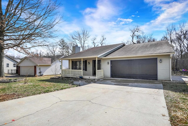 ranch-style home featuring covered porch and a garage