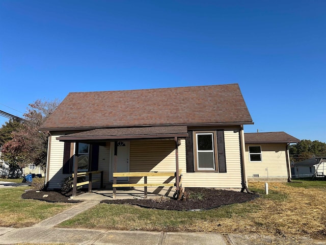 bungalow-style home with a porch and a front lawn