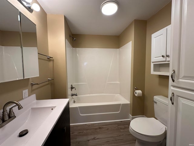 full bathroom featuring toilet, hardwood / wood-style floors, vanity, and bathing tub / shower combination