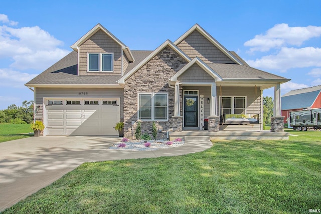 craftsman-style home featuring a front yard, a garage, and a porch