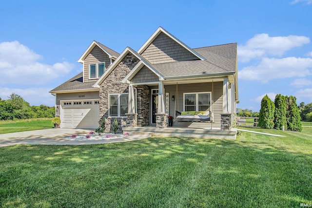 craftsman inspired home featuring a porch, a front yard, and a garage