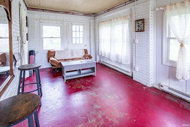 sunroom with baseboard heating and a healthy amount of sunlight