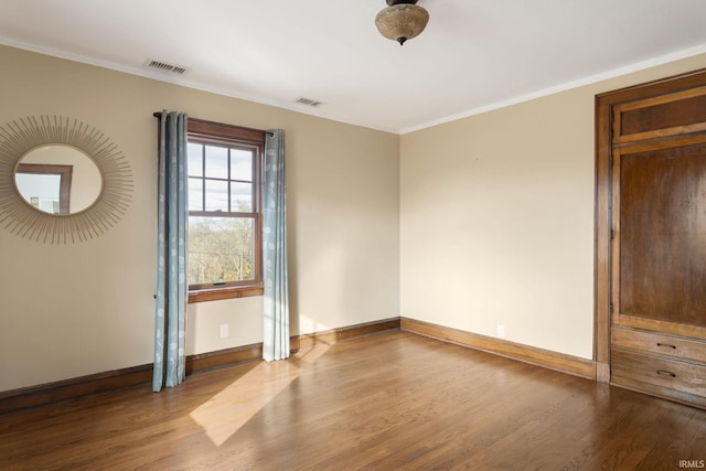 unfurnished room featuring light wood-type flooring and ornamental molding