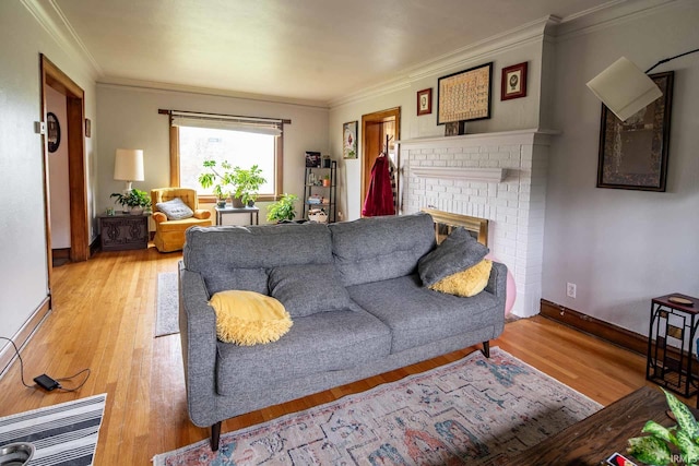 living room featuring a fireplace, light hardwood / wood-style floors, and crown molding