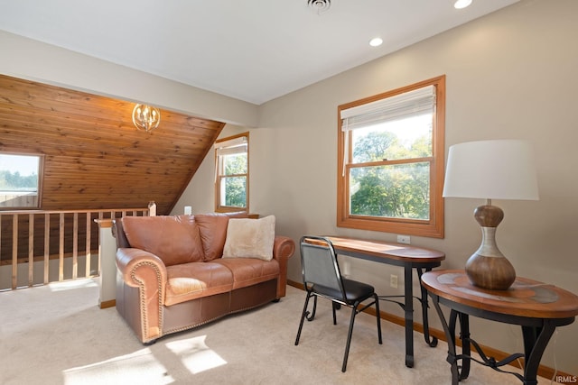 carpeted office with lofted ceiling and a wealth of natural light