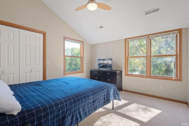 bedroom with a closet, ceiling fan, multiple windows, and light colored carpet