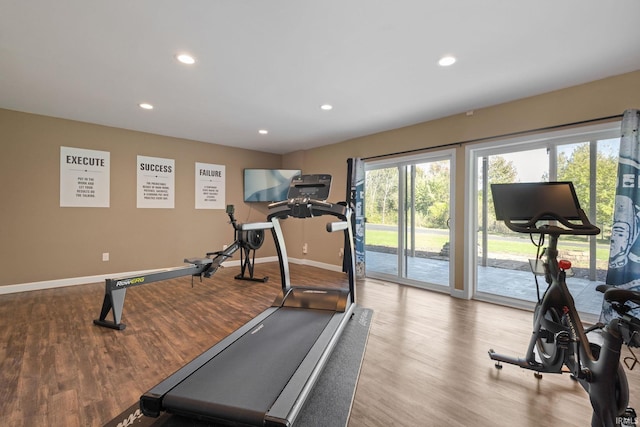 workout room with light hardwood / wood-style flooring