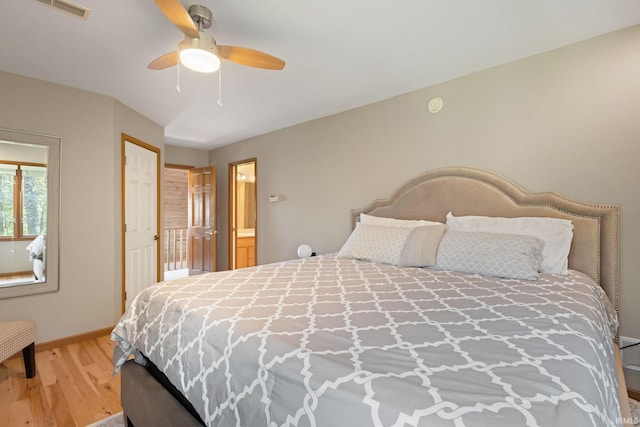 bedroom with ensuite bath, hardwood / wood-style floors, and ceiling fan