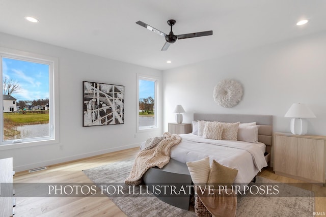 bedroom featuring light hardwood / wood-style floors and ceiling fan