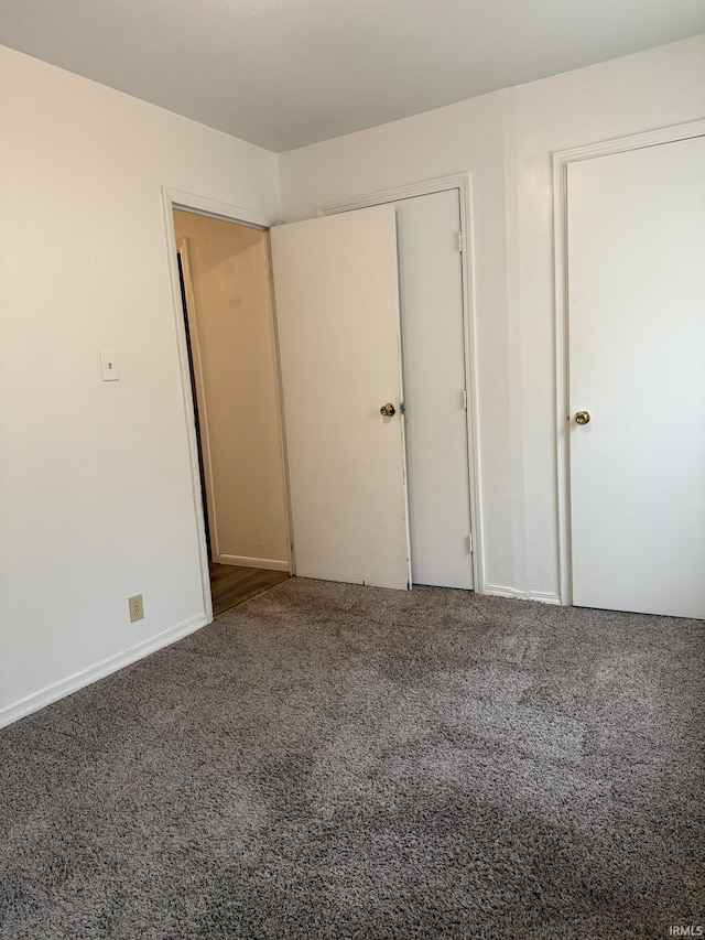 unfurnished bedroom with carpet floors and a closet