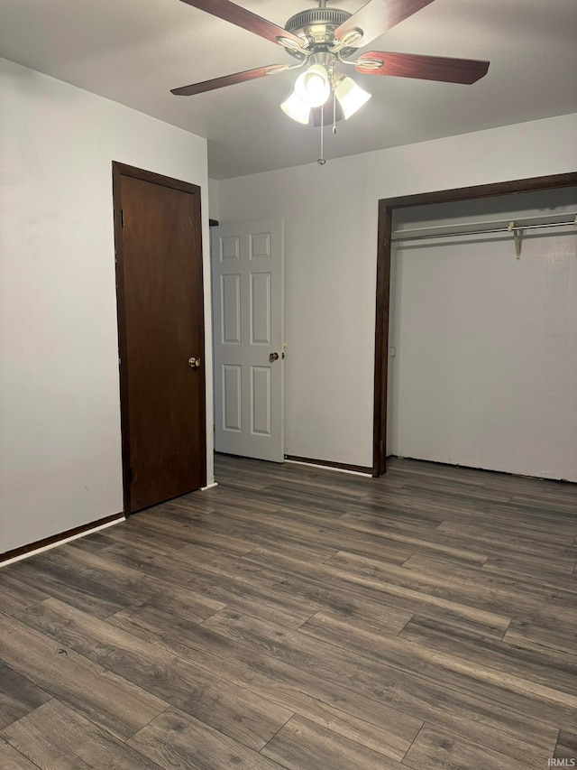 unfurnished bedroom with dark wood-type flooring and ceiling fan