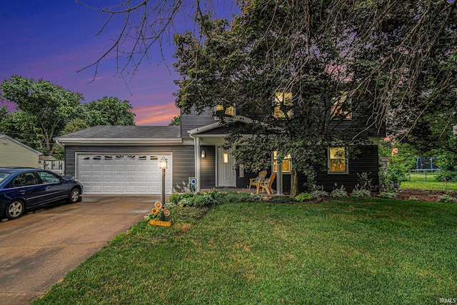 view of front of house featuring a yard and a garage