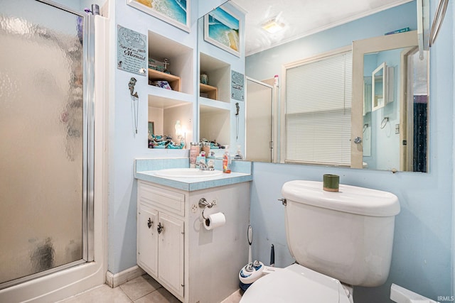 bathroom featuring vanity, a shower with shower door, toilet, and tile patterned floors