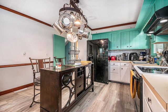 kitchen with white cabinets, white electric range oven, light hardwood / wood-style flooring, black refrigerator, and ventilation hood