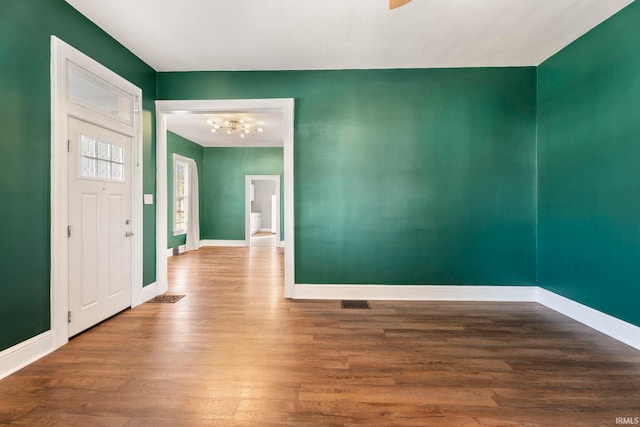 foyer featuring a notable chandelier and hardwood / wood-style flooring