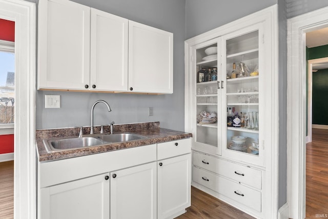 kitchen featuring sink, white cabinets, and dark wood-type flooring