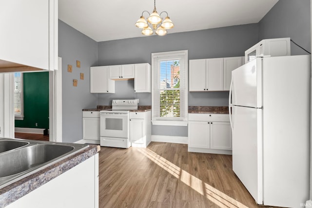 kitchen with a chandelier, white cabinetry, light hardwood / wood-style flooring, and white appliances