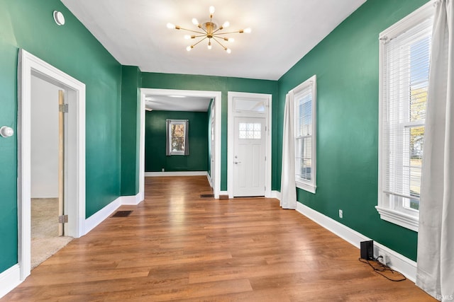 entryway featuring an inviting chandelier and hardwood / wood-style floors