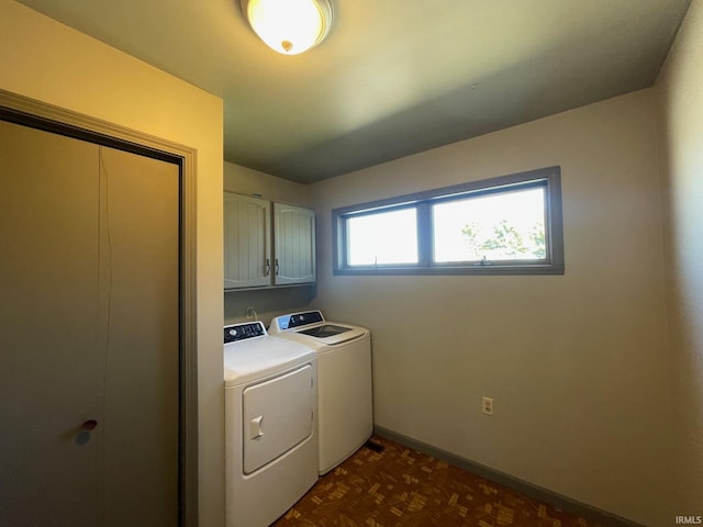 laundry area featuring washer and dryer and cabinets