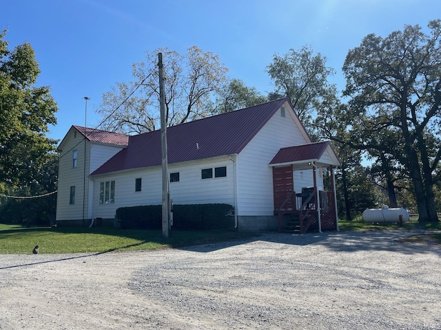 rear view of house featuring metal roof