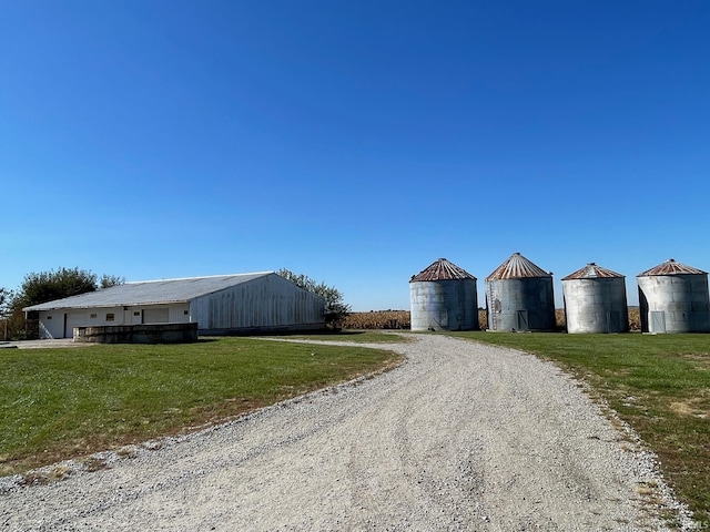exterior space featuring a standing seam roof, metal roof, and a front lawn