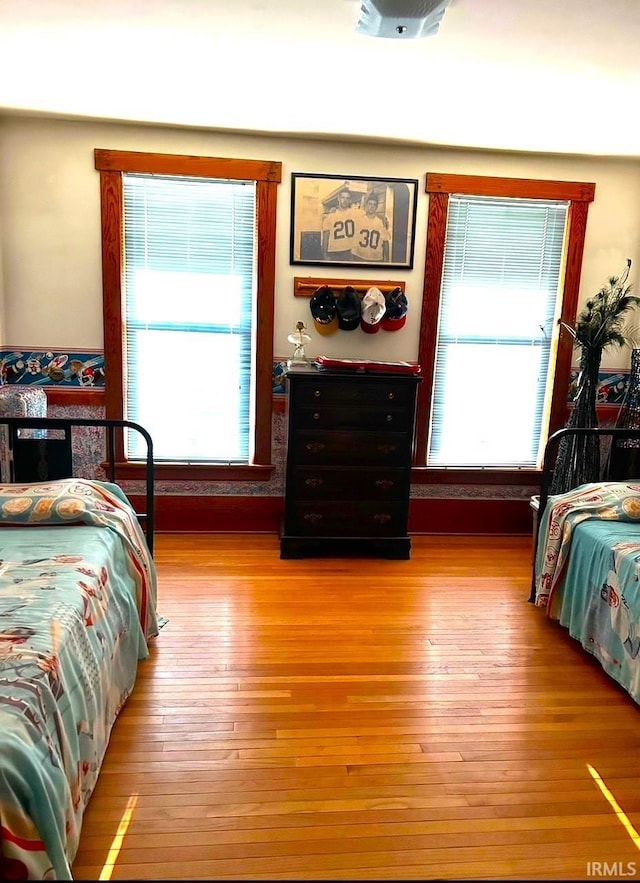 bedroom featuring light hardwood / wood-style flooring and multiple windows