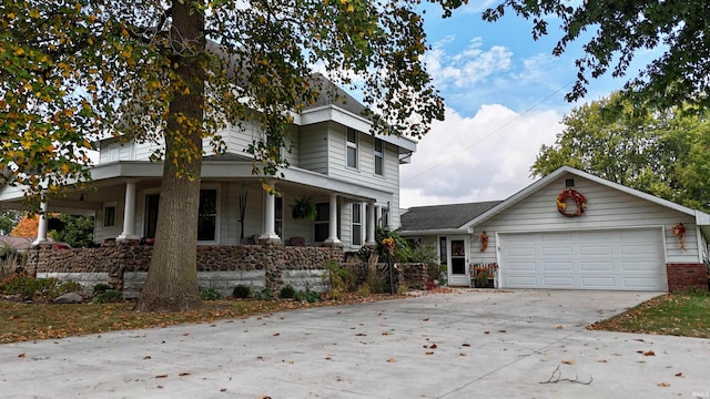 view of front of home featuring a porch and a garage