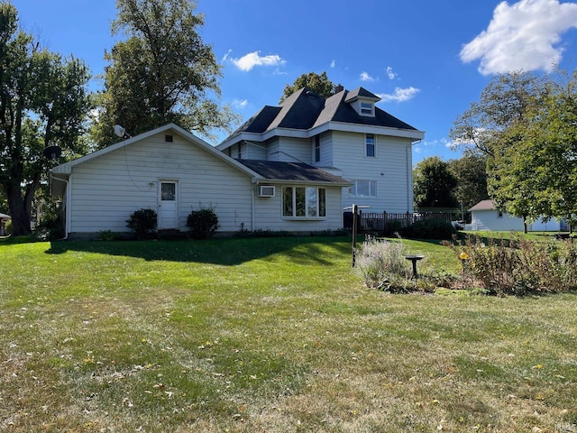 back of house with a lawn