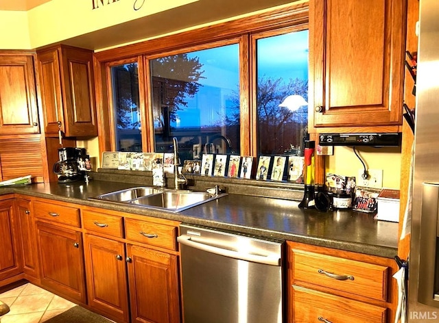 kitchen featuring sink, light tile patterned floors, and dishwasher