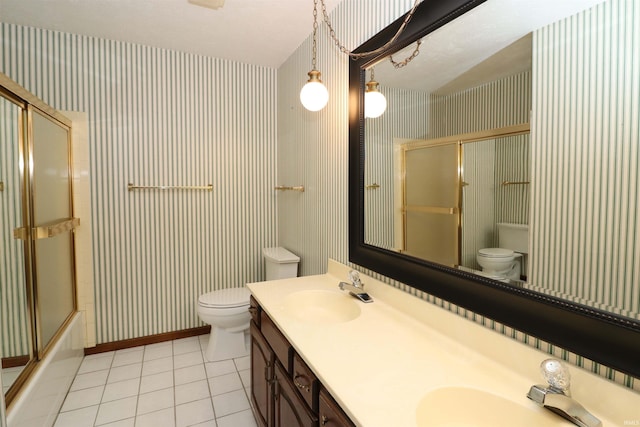 full bathroom with vanity, toilet, tile patterned floors, and bath / shower combo with glass door