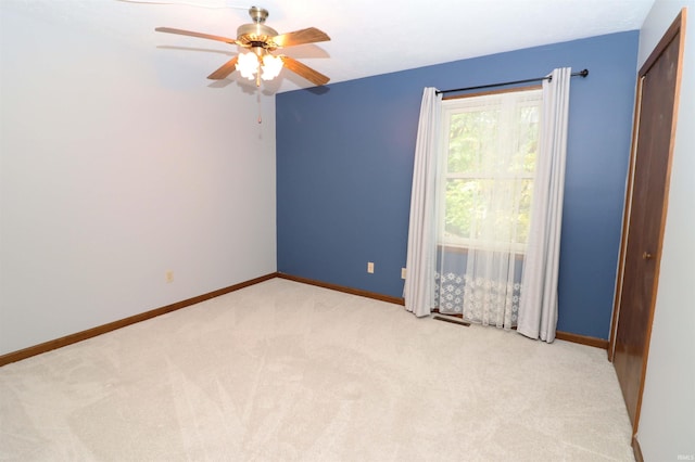 carpeted empty room with ceiling fan