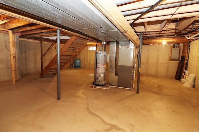 basement with electric panel, heating unit, and water heater