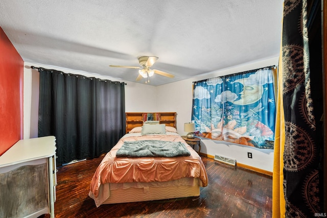 bedroom featuring ceiling fan, hardwood / wood-style flooring, and a textured ceiling