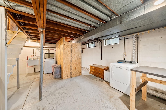 basement featuring washer and dryer and sink