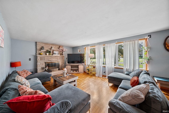 living room with light hardwood / wood-style flooring and a fireplace