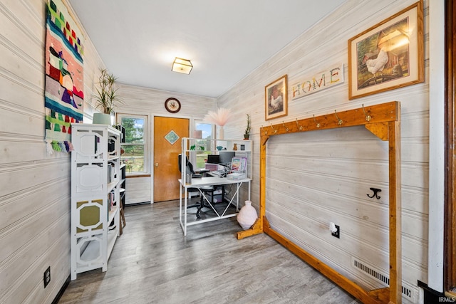 miscellaneous room with wooden walls and wood-type flooring