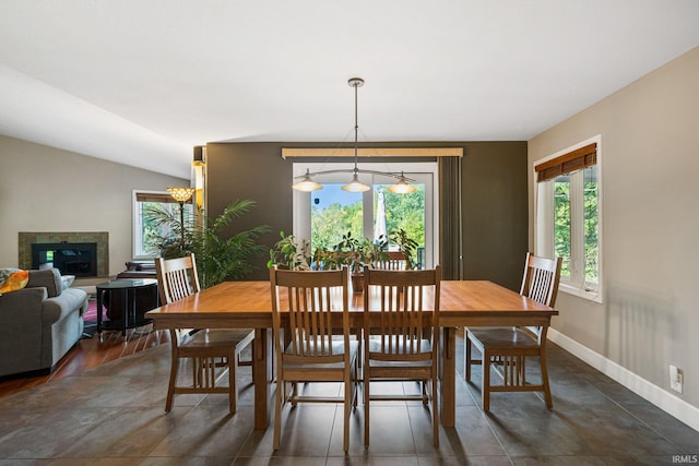 dining area with vaulted ceiling and dark hardwood / wood-style floors