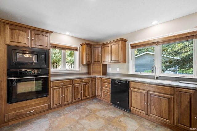 kitchen featuring black appliances, sink, and plenty of natural light