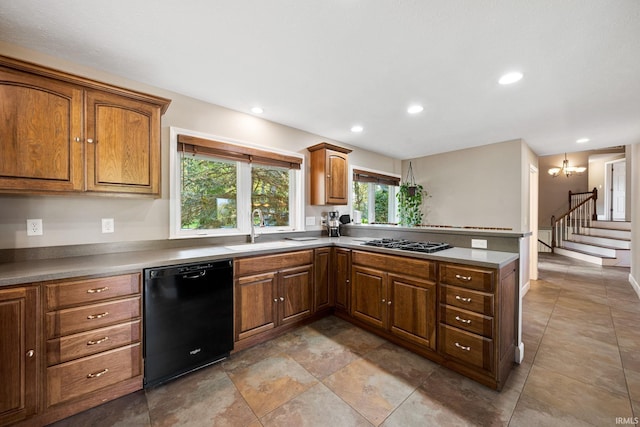 kitchen with a notable chandelier, stainless steel gas stovetop, black dishwasher, and sink