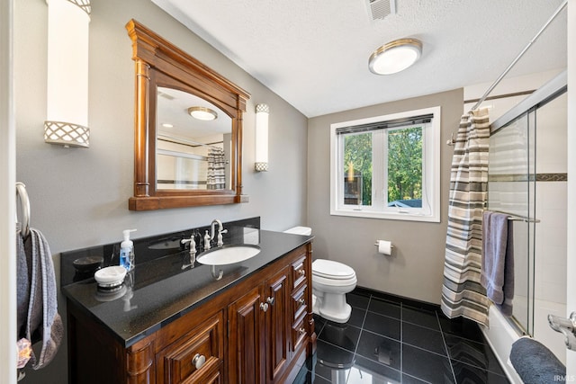 full bathroom with shower / bath combination with curtain, a textured ceiling, toilet, vanity, and tile patterned floors