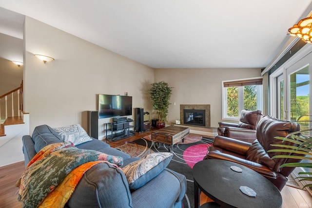 living room featuring hardwood / wood-style flooring and vaulted ceiling