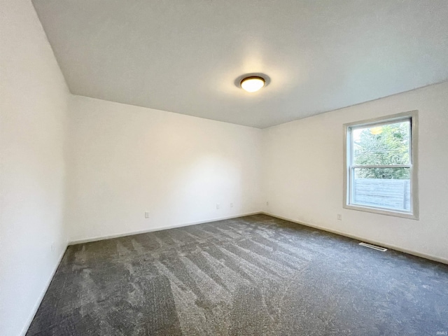 carpeted empty room featuring baseboards and visible vents