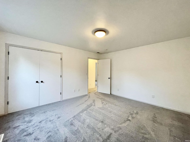 unfurnished bedroom with a closet and carpet